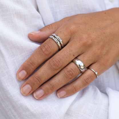 Tiny Stackable Name Ring – Silver – stacked with other rings, worn, close-up
